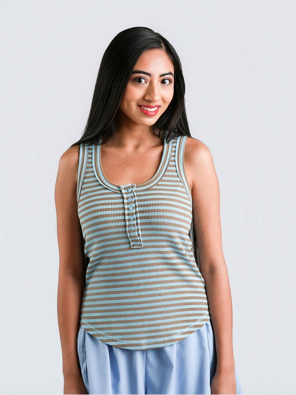 Woman wearing a striped tank top against a plain background