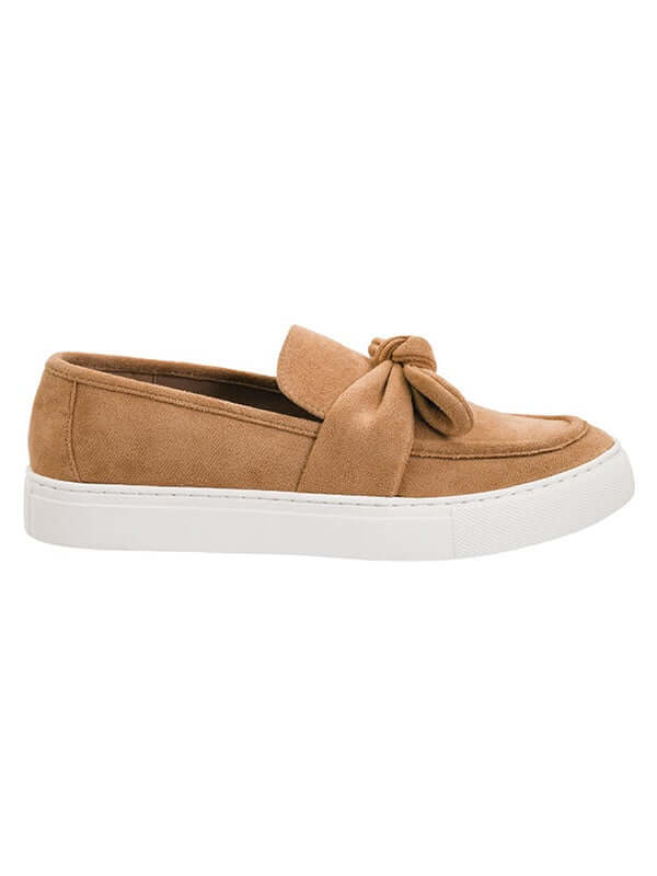 Tan slip-on shoe with a bow detail on a white background