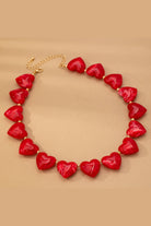 Heart Beaded Statement Necklace worn on a mannequin neck and upper chest, with small gold-toned spacer beads between the hearts.
