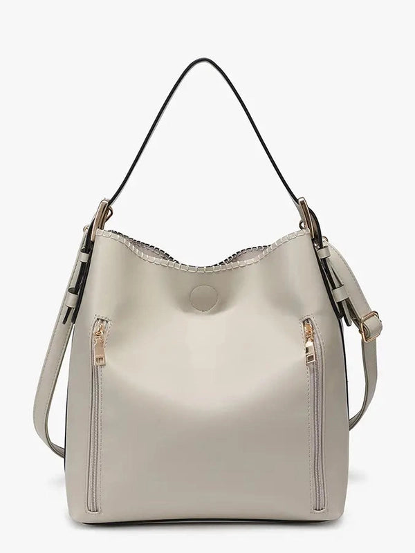Beige handbag with shoulder strap on a white background