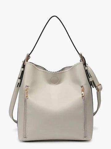 Beige handbag with shoulder strap on a white background