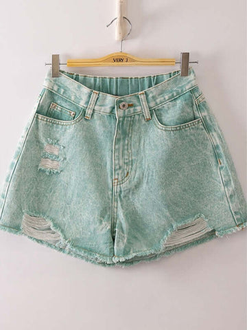 Denim shorts with distressed details on a hanger against a white background
