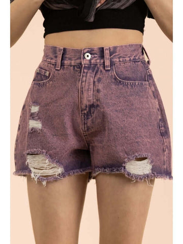 Ripped purple denim shorts on a beige background