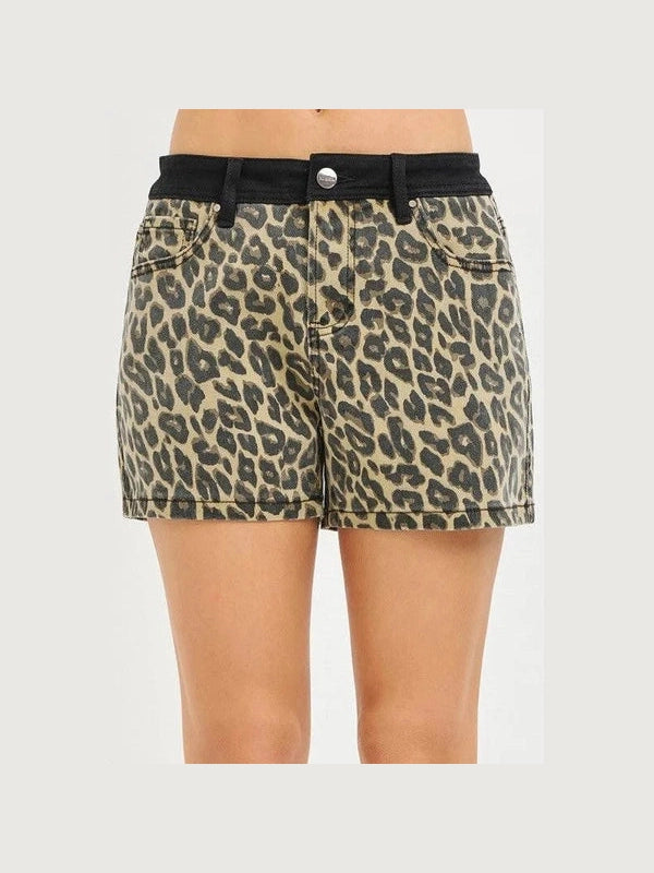 Leopard print shorts with a black belt on a plain background